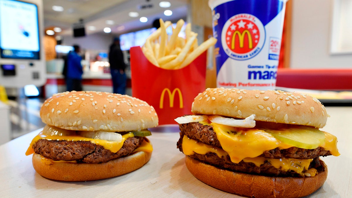 FILE- In this March 6, 2018, file photo, a McDonald's Quarter Pounder, left, and Double Quarter Pound burger is shown with fresh beef in Atlanta. Following years of reformulating at McDonald's, most of the burgers it serves in the U.S. are now preservative-free.As of Wednesday, Sept. 26, the chain says classics like the Big Mac and Quarter Pounder with Cheese are preservative-free, with reformulated buns and sauces. (AP Photo/Mike Stewart, File)