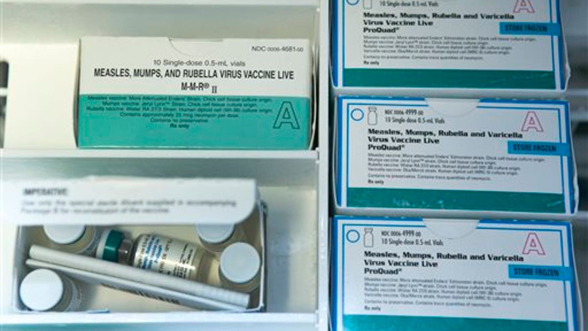 This Thursday, Jan. 29, 2015, file photo, shows boxes of the measles, mumps and rubella virus vaccine (MMR) and measles, mumps, rubella and varicella vaccine inside a freezer at a doctor's office in Northridge, Calif. (AP Photo/Damian Dovarganes, File)