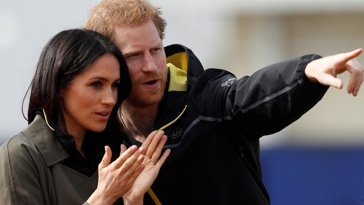 Britain's Prince Harry, Patron of the Invictus Games Foundation, and Meghan Markle watch athletes at the team trials for the Invictus Games Sydney 2018 at the University of Bath Sports Training Village in Bath, Britain, April 6, 2018. REUTERS/Peter Nicholls - RC1A1D29ABF0
