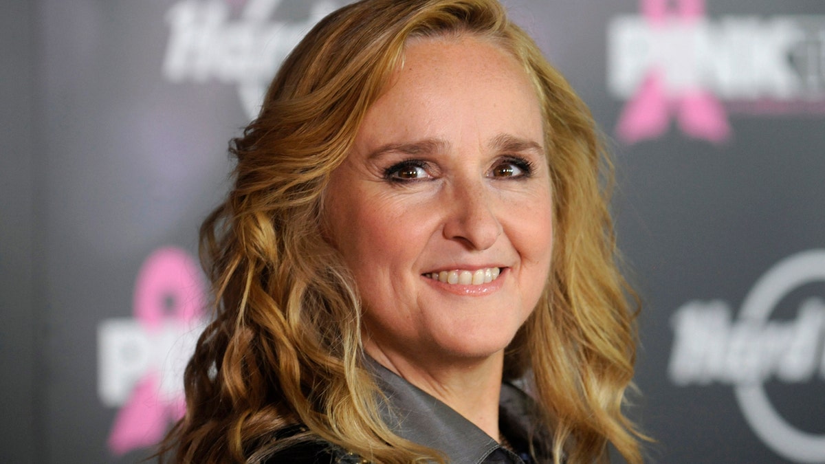 Singer Melissa Etheridge poses for photographers after receiving a star on the Hollywood Walk of Fame in Los Angeles September 27, 2011. REUTERS/Phil McCarten (UNITED STATES - Tags: ENTERTAINMENT HEADSHOT) - RTR2RX4W