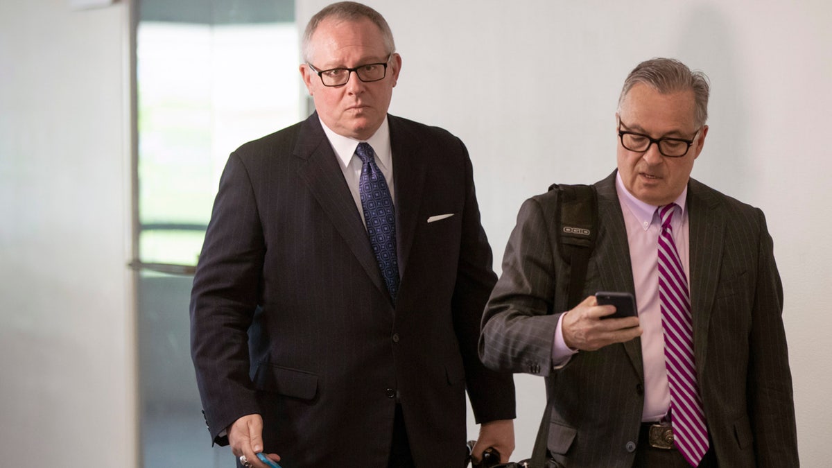 Former Donald Trump campaign official Michael Caputo, left, joined by his attorney Dennis C. Vacco, leaves after being interviewed by Senate Intelligence Committee staff investigating Russian meddling in the 2016 presidential election, on Capitol Hill in Washington, Tuesday, May 1, 2018. Caputo had previously appeared before the House Intelligence Committee as it was investigating election interference by Russia. (AP Photo/J. Scott Applewhite)