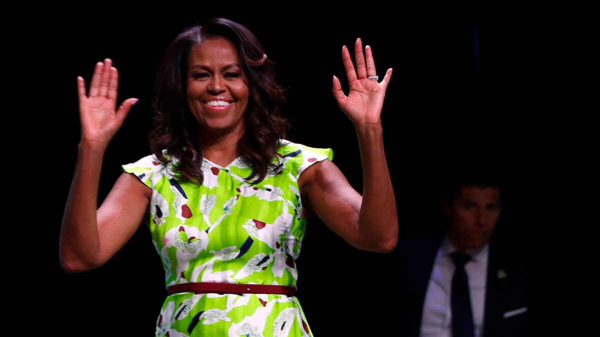 Former first lady Michelle Obama waves as she arrives to speak at the American Library Association annual conference in New Orleans, Friday, June 22, 2018. (AP Photo/Gerald Herbert)