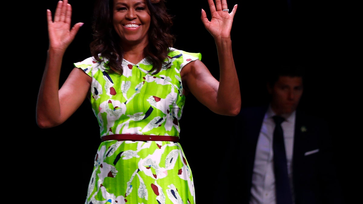 Former first lady Michelle Obama waves as she arrives to speak at the American Library Association annual conference in New Orleans, Friday, June 22, 2018. (AP Photo/Gerald Herbert)