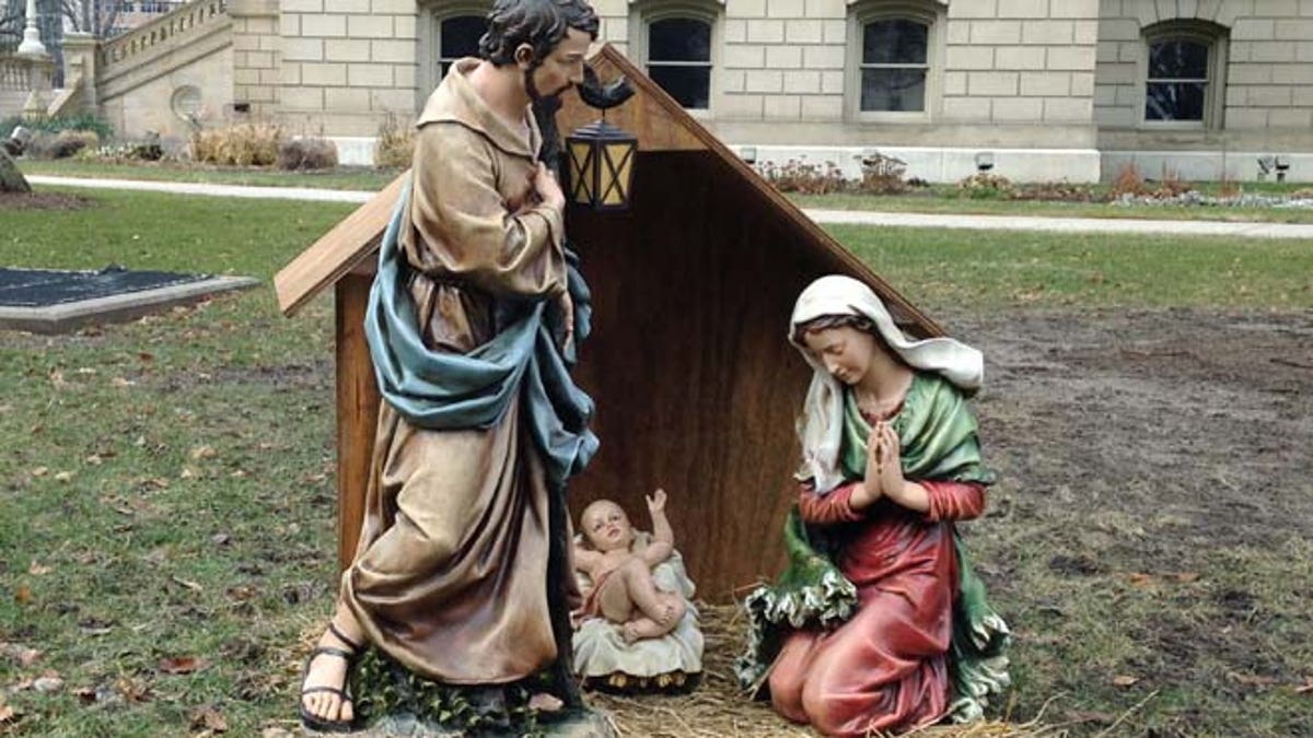 Dec. 19, 2014: A nativity scene is displayed on the State House grounds in Lansing, Mich. About 50 people sang Christmas carols and prayed to welcome the temporary nativity scene to the Capitol in a scene that likely wouldnt have happened were it not for a group of Satanists from Detroit. The three statues of the infant Jesus Christ and his parents, Mary and Joseph, stand about three feet tall in a small wooden manger were placed just south of the east steps of the Capitol. The display was celebrated by speakers at a brief ceremony as not only a symbol of the season but of a symbol of the right to celebrate that season. 