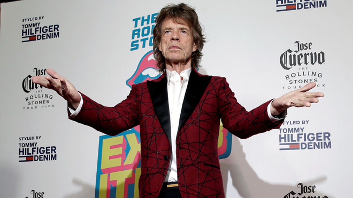 Mick Jagger of The Rolling Stones poses for photographers as the band arrives for the opening of the new exhibit 