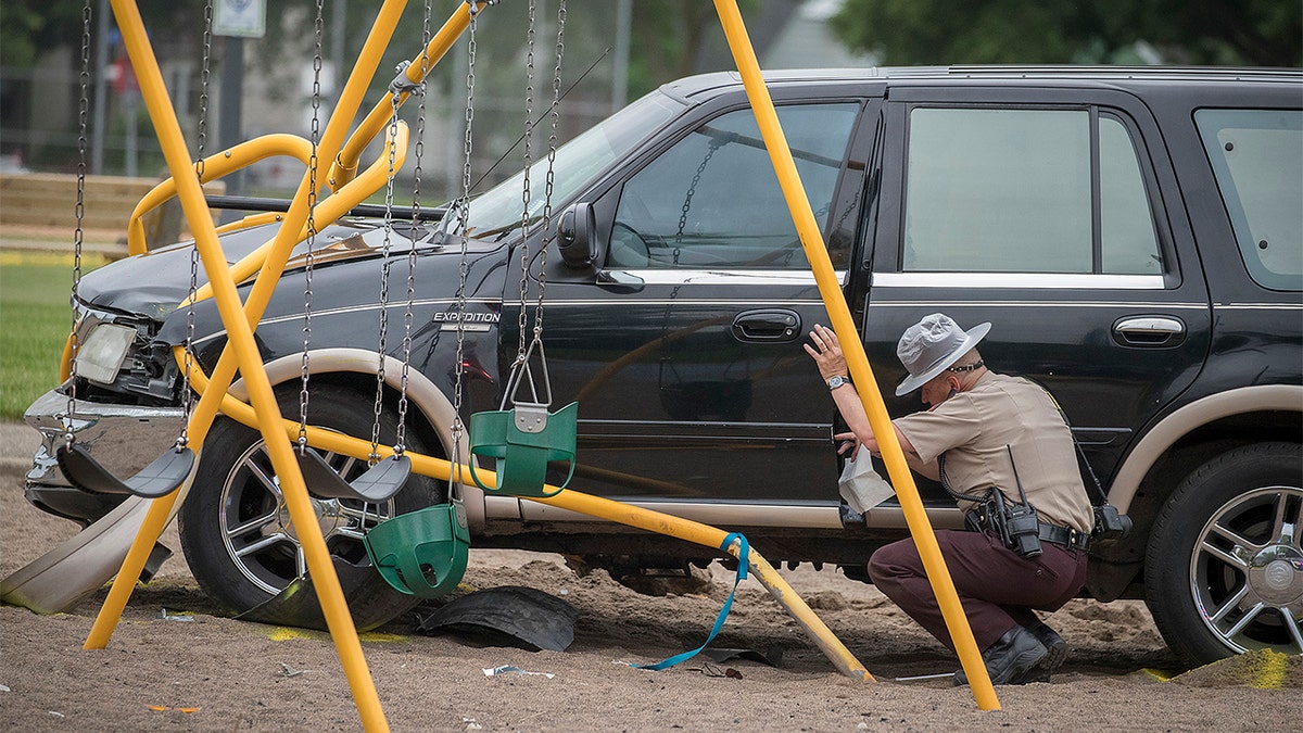 Minnesota State Patrol investigates the scene where a motorist being pursued by the State Patrol veered into a Minneapolis school playground Monday, June 11, 2018. At least two young children suffered life-threatening injuries after police say a motorist being pursued by the State Patrol veered into a Minneapolis park and struck them. The State Patrol says the driver ran from the crash scene and was arrested. (Elizabeth Flores/Star Tribune via AP)
