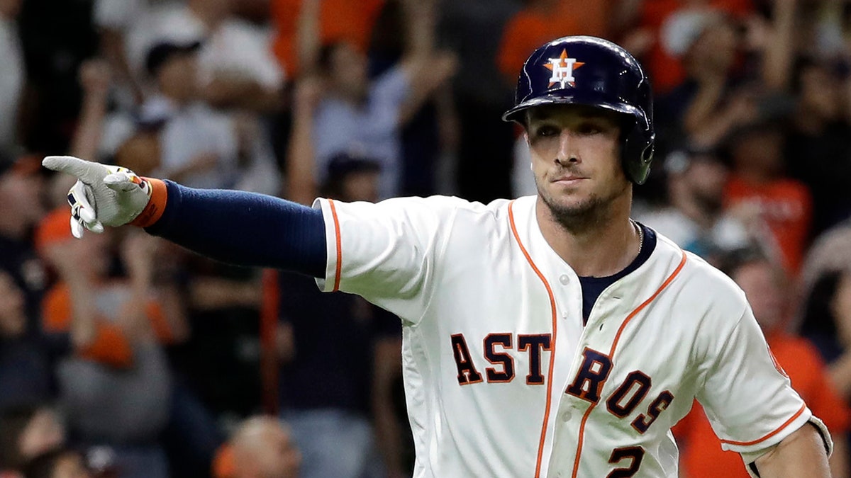 Houston Astros' Alex Bregman points to dugout after hitting a game-winning double to score two runs against the Tampa Bay Rays during the ninth inning of a baseball game Monday, June 18, 2018, in Houston. The Astros won 5-4. (AP Photo/David J. Phillip)