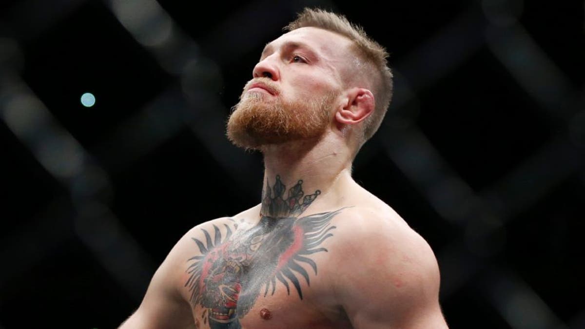 Nov 12, 2016; New York, NY, USA; Conor McGregor (blue gloves) celebrates after defeating Eddie Alvarez (red gloves) in their lightweight title bout during UFC 205 at Madison Square Garden. Mandatory Credit: Adam Hunger-USA TODAY Sports