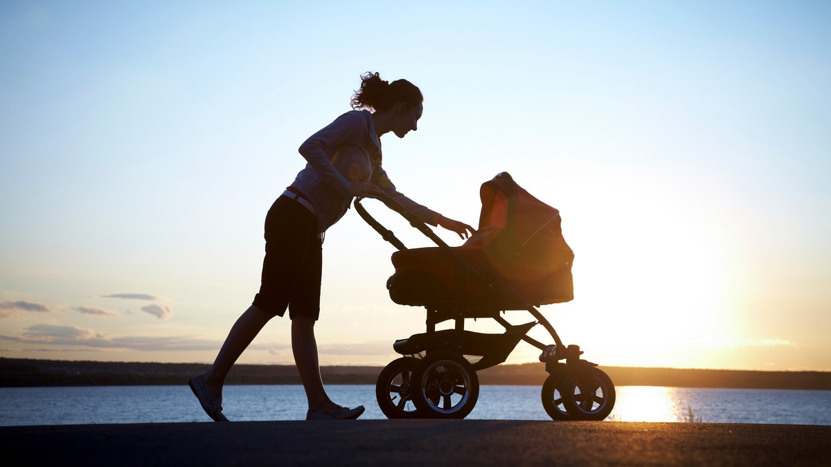 mom walking baby stroller istock large