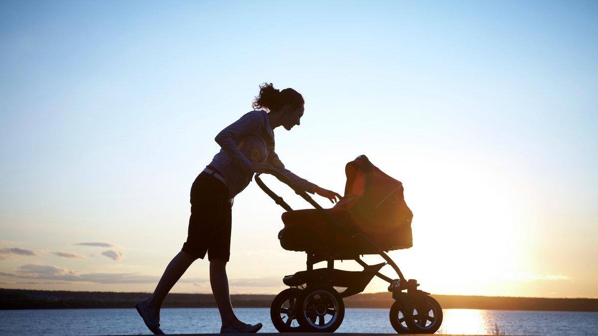 mom walking baby stroller istock large