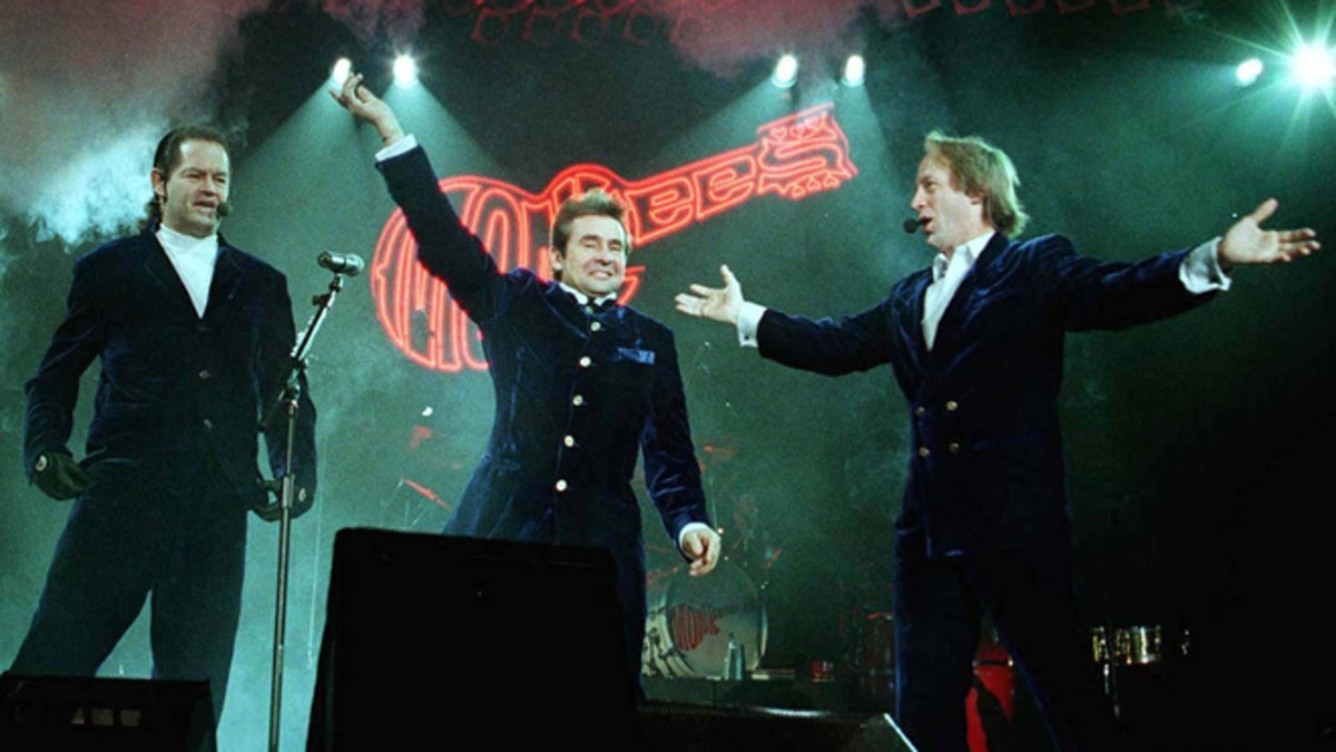 The "Monkees," formed in 1965 for an NBC sitcom about a Beatles-like band, plan to reunite next year for their first tour together in more than four years, producer David Fishof said November 28, 2000. Band members (L-R) Mickey Dolenz, Davy Jones and Peter Tork, shown during their 1997 tour, will embark in March on a 15-city "Monkee Mania Returns 2001" tour, Fishof said. RC/SV - RTRBDXB