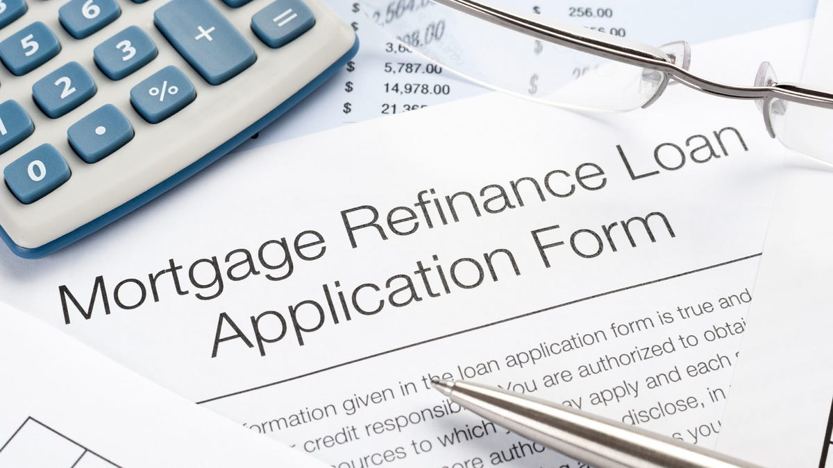 Mortgage Refinance Application Form with pen, calculator