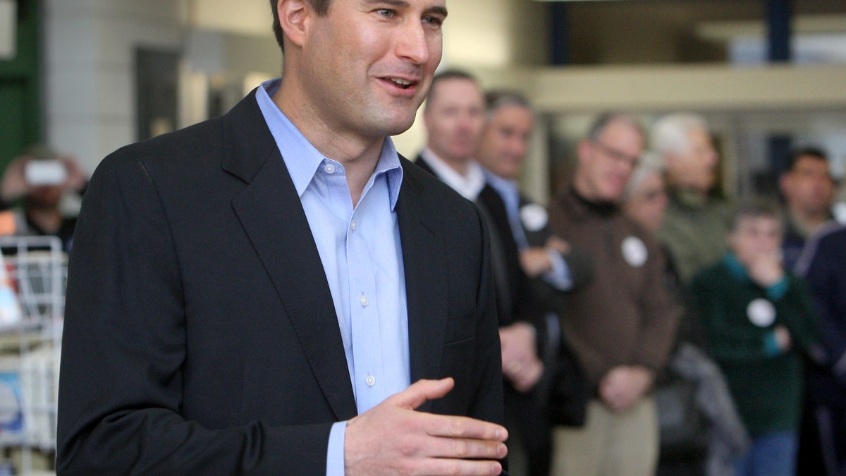 FILE: Seth Moulton speaks at a Democratic caucus in the library of Salem High School in Salem, Mass.