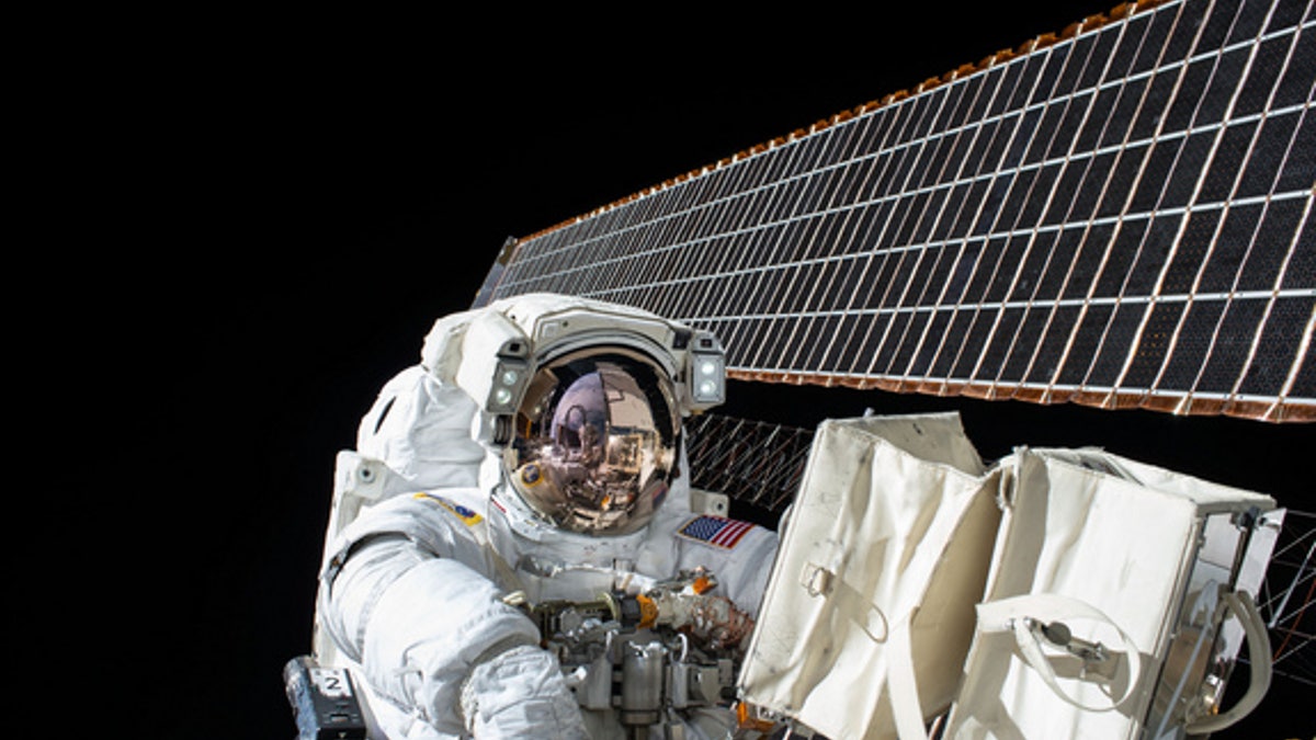 NASA astronaut Scott Kelly is seen during a spacewalk outside the International Space Station on Nov. 6, 2015. He and crewmate Tim Kopra will likely perform a surprise spacewalk on Monday, Dec. 21, to repair the station's stuck Mobile Transport