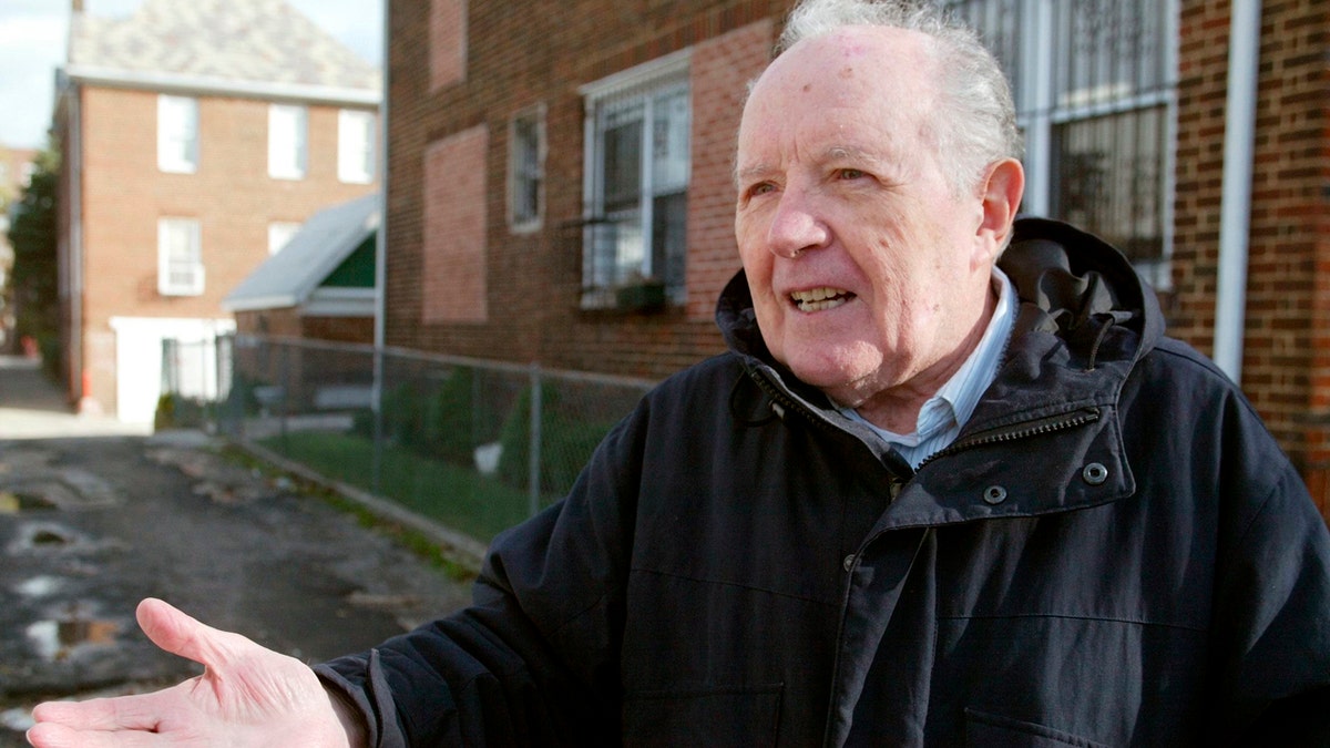 FILE - In this Nov. 20, 2003 file photo, Jakiw Palij, a former Nazi concentration camp guard, stands in front of a building in the Queens borough of New York. The White House says that Palij, a 95-year-old former Nazi concentration camp guard has been deported to Germany, 14 years after a judge ordered his expulsion. In a statement, the White House said the deportation of Palij, who lived in New York City, was carried out early Tuesday Aug. 21, 2018. (Suzanne DeChillo/The New York Times via AP, File)