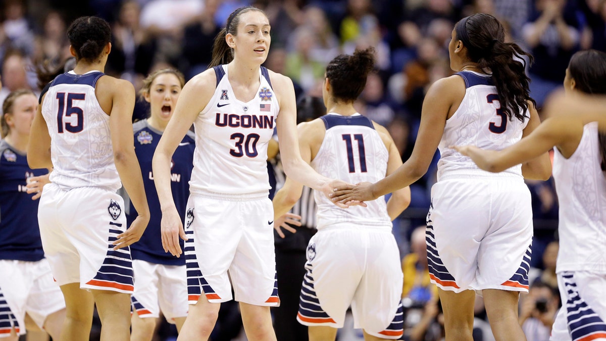 Connecticut's Breanna Stewart (30) greets teammates during a timeout during the first half of the championship game against Syracuse, at the women's Final Four in the NCAA college basketball tournament Tuesday, April 5, 2016, in Indianapolis. (AP Photo/Michael Conroy)