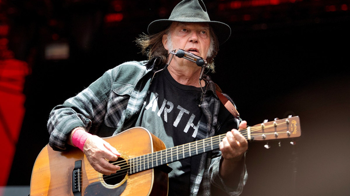 Canadian singer-songwriter Neil Young performs at the Orange Stage at the Roskilde Festival in Roskilde, Denmark, on July 1, 2016.