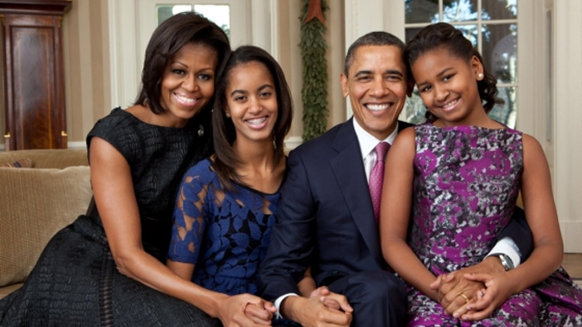 President Barack Obama, First Lady Michelle Obama, and their daughters, Malia, left, and Sasha, right, sit for a family portrait in the Oval Office, Dec. 11, 2011. (Official White House Photo by Pete Souza)