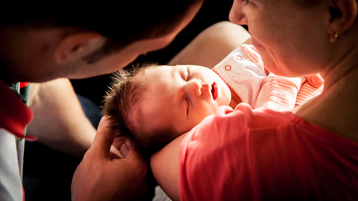 newborn baby with parents istock large