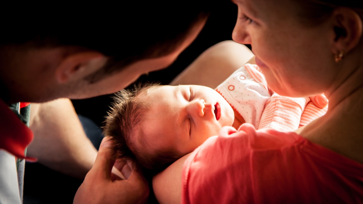 newborn baby with parents istock large