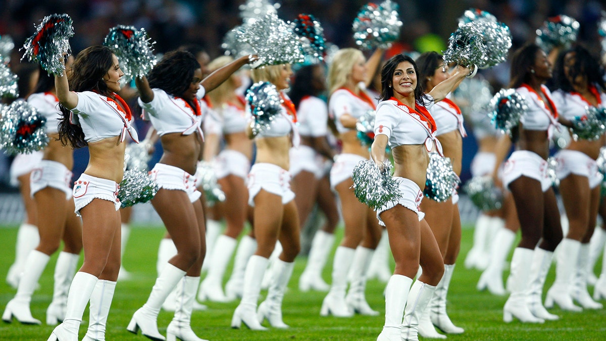 Miami Dolphins cheerleaders in white on the field