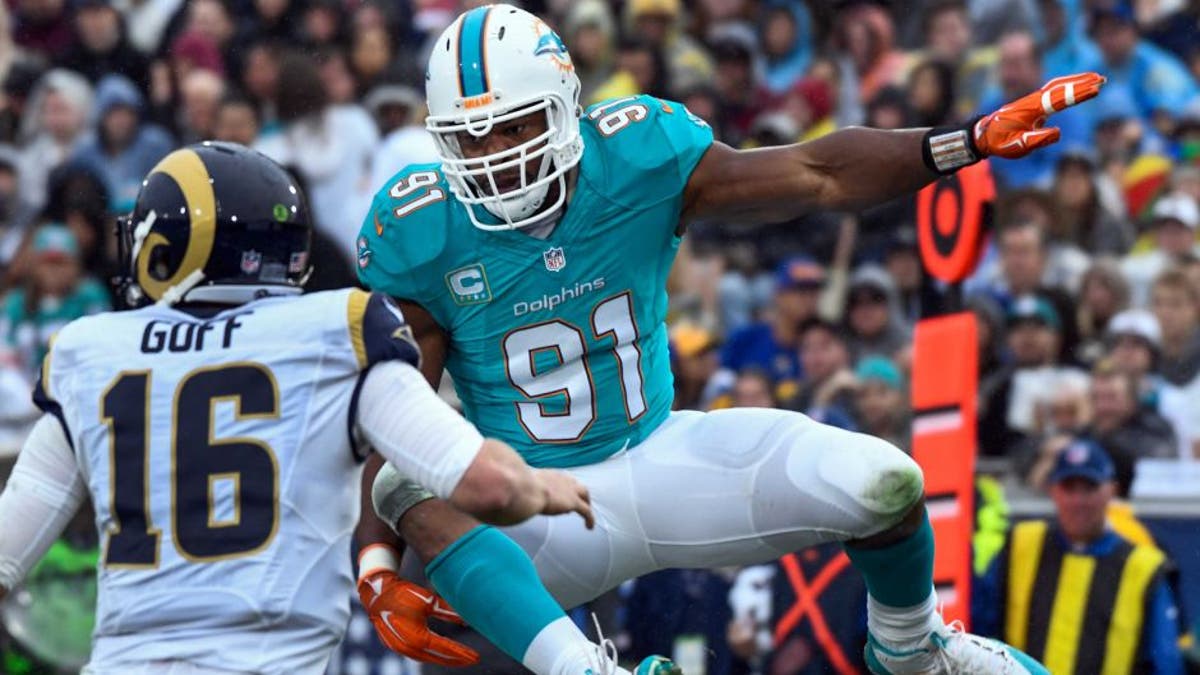 Nov 20, 2016; Los Angeles, CA, USA; Miami Dolphins defensive end Cameron Wake (91) leaps as he pressures Los Angeles Rams quarterback Case Keenum (17) during the second quarter at Los Angeles Memorial Coliseum. Mandatory Credit: Robert Hanashiro-USA TODAY Sports