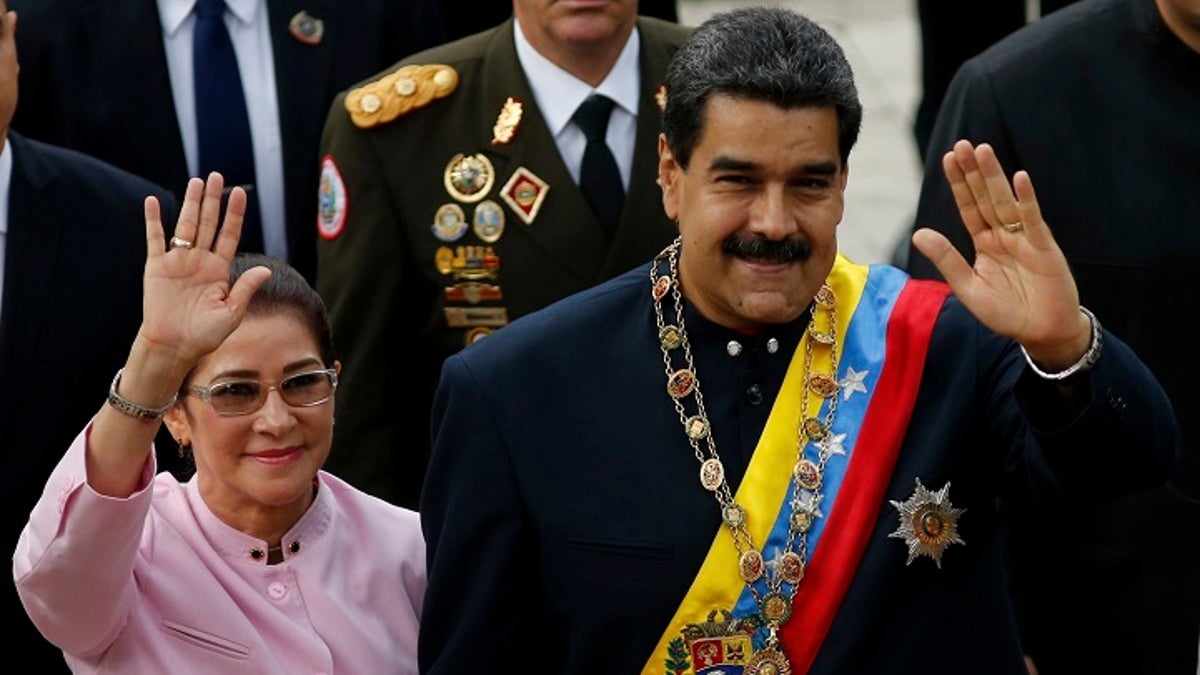 Venezuela's President Nicolas Maduro, right, and his wife Cilia Flores wave as they arrive to the National Assembly building for a session of the Constitutional Assembly in Caracas, Venezuela, Thursday, Aug. 10, 2017. The new constitutional assembly has declared itself as the superior body to all other governmental institutions, including the opposition-controlled congress. (AP Photo/Ariana Cubillos)