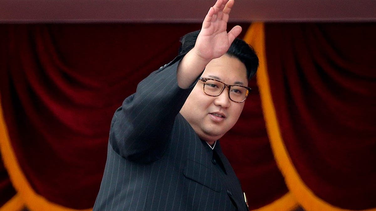 Kim Jong Un waves during parade