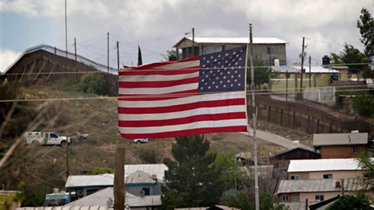 In this April 22 photo, the American flag flies along the international border in Nogales, Ariz. (AP Photo)