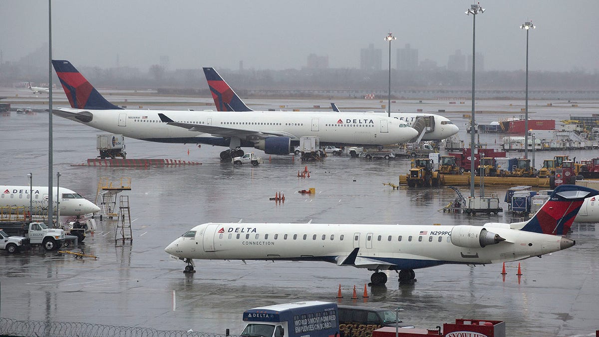 Delta airplanes are grounded, Friday, March 2, 2018, in New York. Airlines have cancelled many flights out of New York as a severe storm arrives in the northeast. (AP Photo/Mark Lennihan)