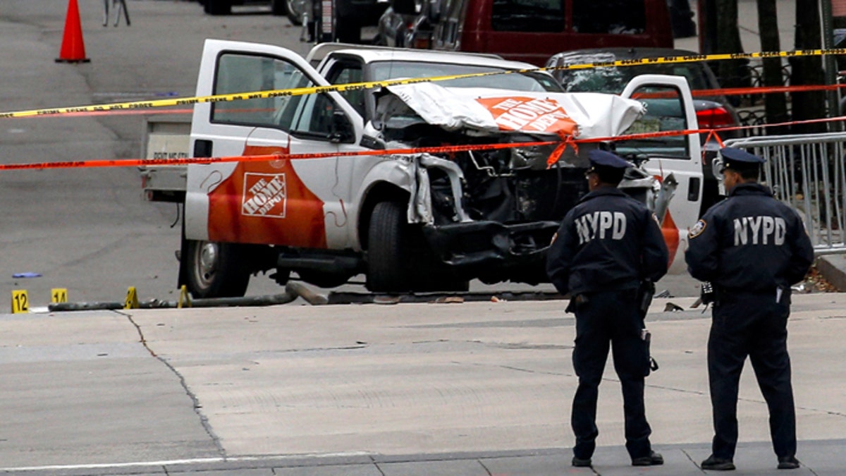 Police investigate a pickup truck used in an attack on the West Side Highway in lower Manhattan in New York City, U.S., November 1, 2017.REUTERS/Brendan McDermid - RC1532646A00