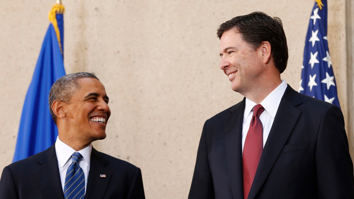 U.S. President Barack Obama (L) and new FBI Director James Comey smile during Comey's installation ceremony at the FBI Headquarters in Washington October 28, 2013. 
REUTERS/Kevin Lamarque  (UNITED STATES - Tags: POLITICS) - GM1E9AT04EZ01