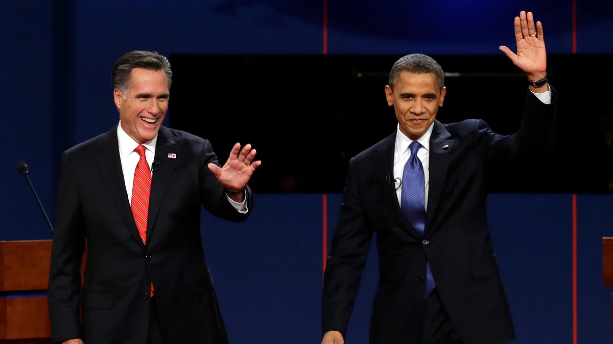 Republican presidential nominee Mitt Romney and President Barack Obama wave to the audience during the first presidential debate at the University of Denver, Wednesday, Oct. 3, 2012, in Denver. (AP Photo/Charlie Neibergall)