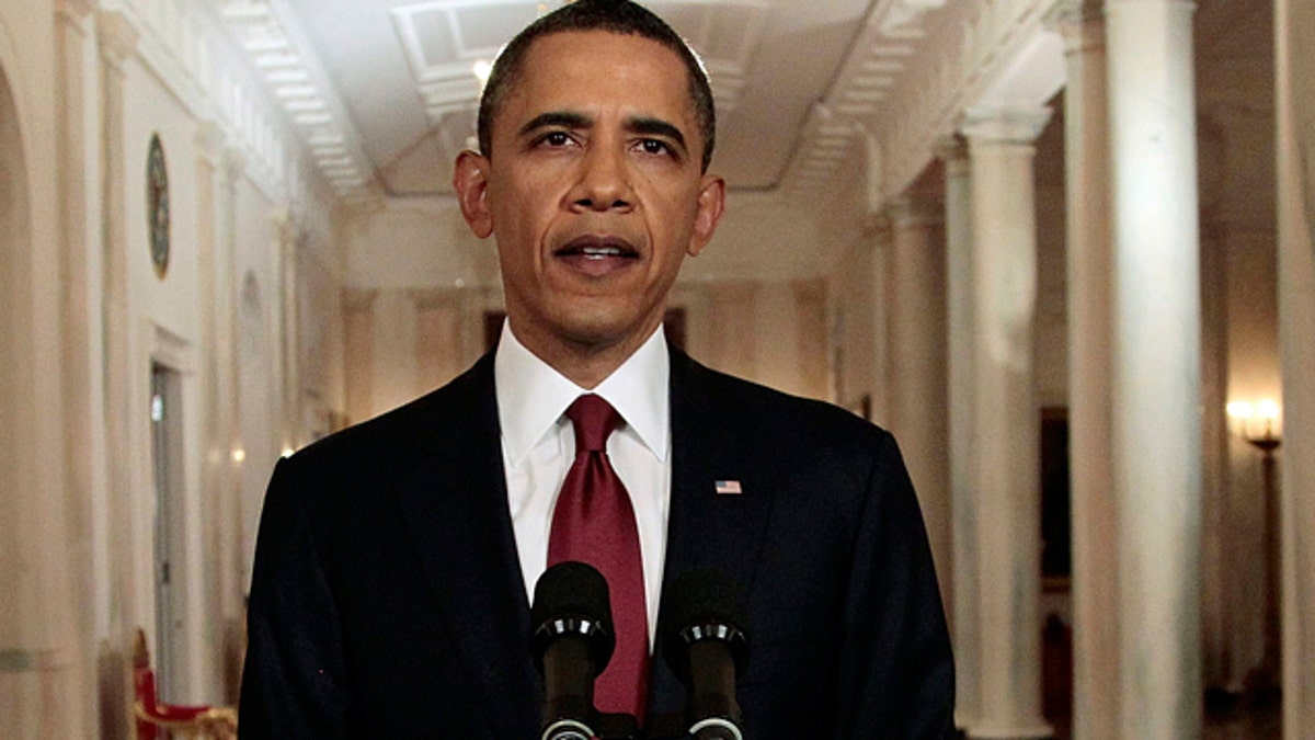 May 1: President Barack Obama reads his statement to photographers after making a televised statement on the death of Osama bin Laden from the East Room of the White House