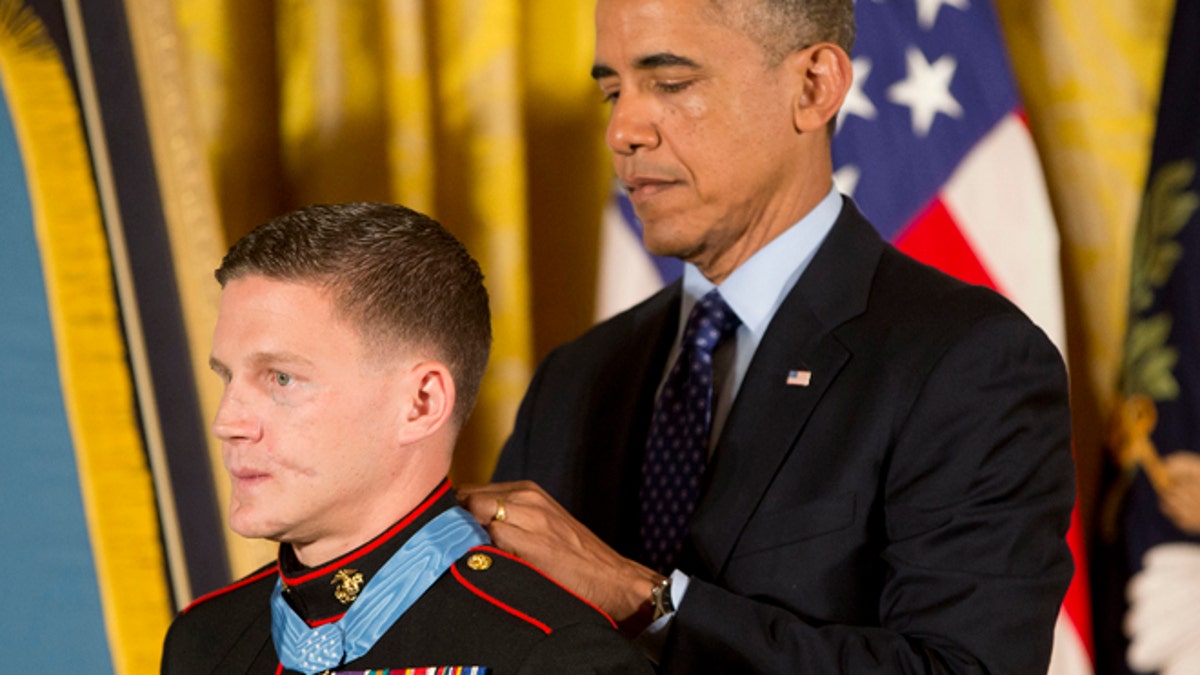 June 19: President Barack Obama awards the Medal of Honor to retired Marine Cpl. William 'Kyle' Carpenter in the East Room of the White House in Washington.