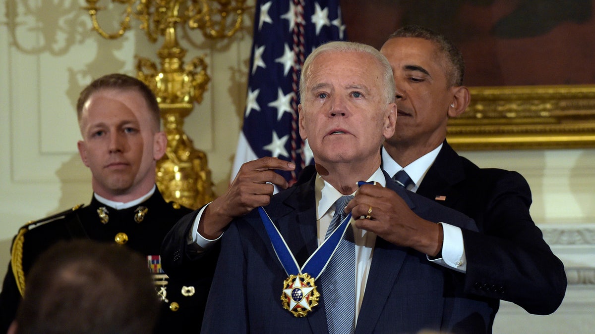 President Barack Obama presents Vice President Joe Biden with the Presidential Medal of Freedom during a ceremony in the State Dining Room of the White House in Washington, Thursday, Jan. 12, 2017. (AP Photo/Susan Walsh)