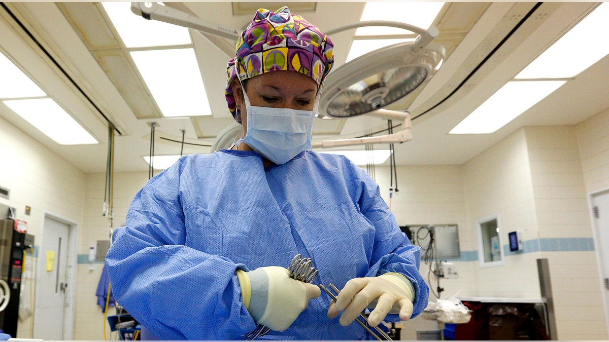 Surgical Tech Melissa Ellis prepares an OR room in the University of Mississippi Medical Center in Jackson, Mississippi October 4, 2013. Mississippi is one of at least 20 states that has decided not to expand Medicaid under the Affordable Care Act, better known as 