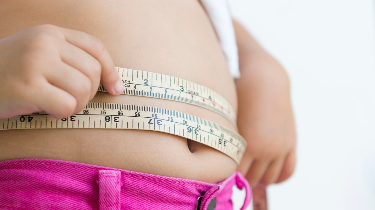 obese girl measuring tape