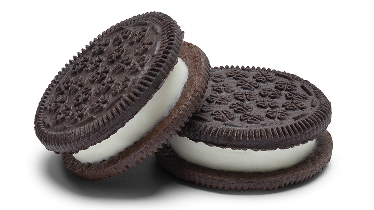 Two Extra Fat Chocolate Sandwich Cookies With Frosting Isolated on White Background.