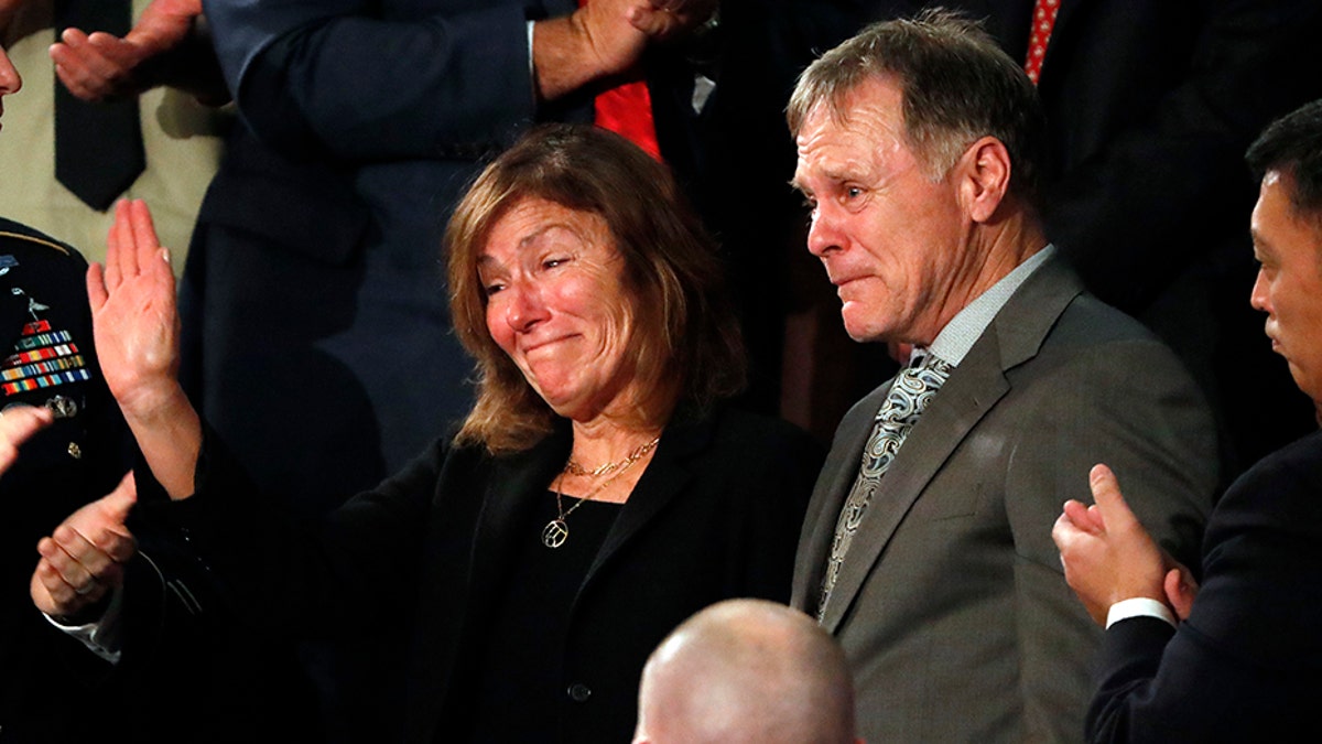 American student Otto Warmbier's parents Fred and Cindy Warmbier cry as U.S. President Donald Trump talks about the death of their son after his arrest in North Korea during the State of the Union address to a joint session of the U.S. Congress on Capitol Hill in Washington, U.S. January 30, 2018. REUTERS/Leah Millis - HP1EE1V0ANI1F