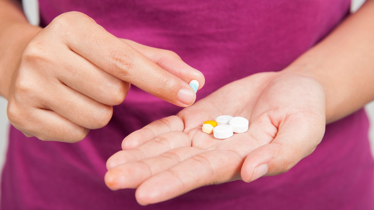 painkillers pills medication in hand istock