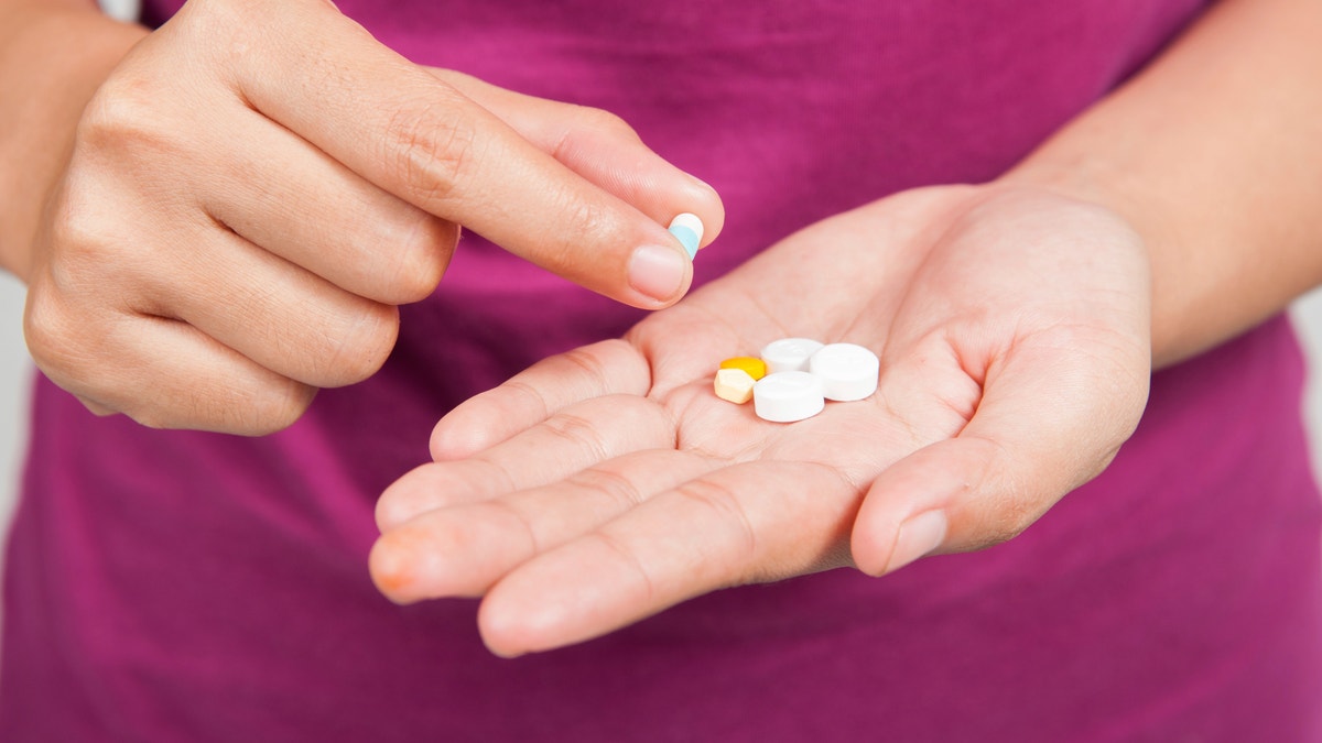 painkillers pills medication in hand istock