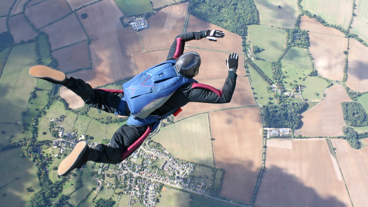 Skydiver in freefall high up in the air