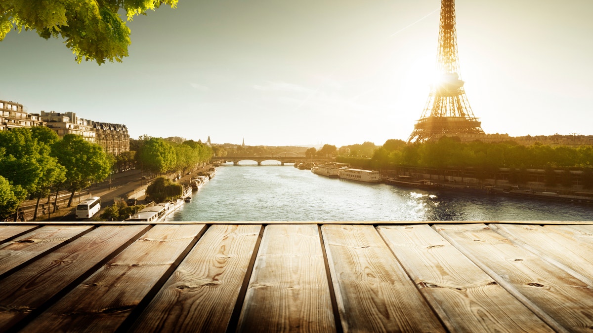 background with wooden deck table and  Eiffel tower in Paris