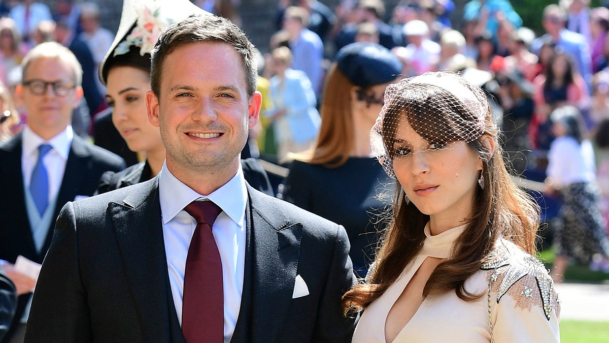 Patrick J. Adams and wife Troian Bellisario arrive a for the wedding ceremony of Prince Harry and Meghan Markle at St. George's Chapel in Windsor Castle in Windsor, near London, England, Saturday, May 19, 2018. (Ian West/pool photo via AP)