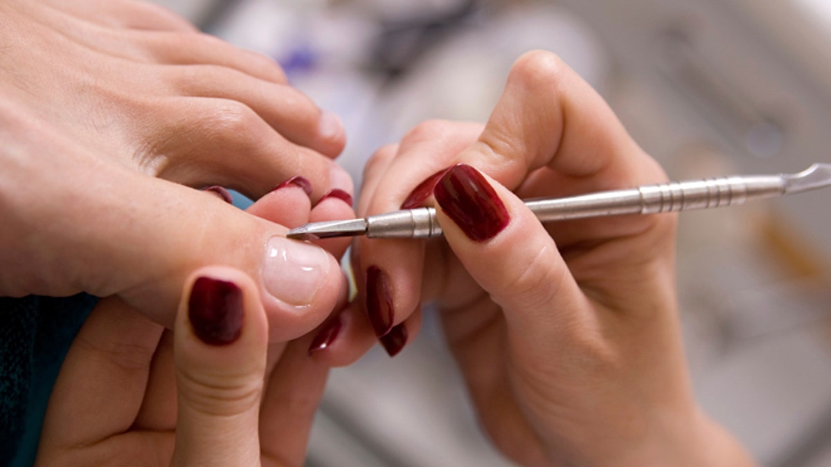 a man and  the procedure of pedicure