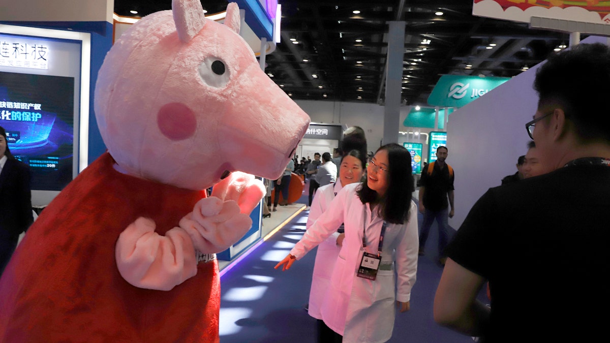 Woman with Peppa Pig mascot