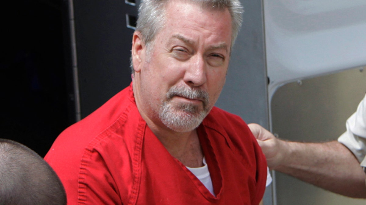 FILE - In this May 8, 2009 file photo, former Bolingbrook, Ill., police officer Drew Peterson arrives for court in Joliet, Ill. Jury selection is set to begin Friday, May 20, 2016, in Chester, Ill., in the murder-for-hire trial of Peterson, who is accused of plotting to kill the prosecutor who put him behind bars in his third wife's death. (AP Photo/M. Spencer Green, File)