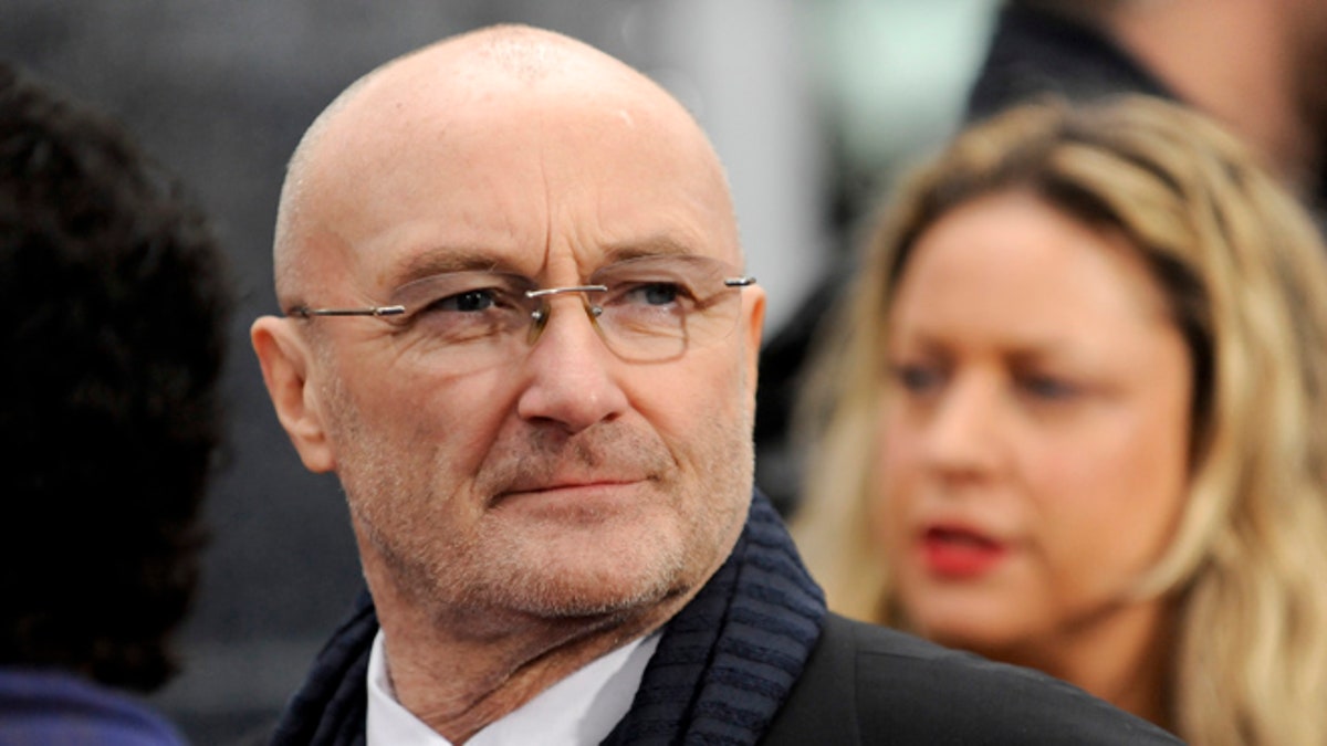 British musician Phil Collins watches his daughter British actress Lily Collins (not pictured) as he arrives at the Hollywood world premiere of 