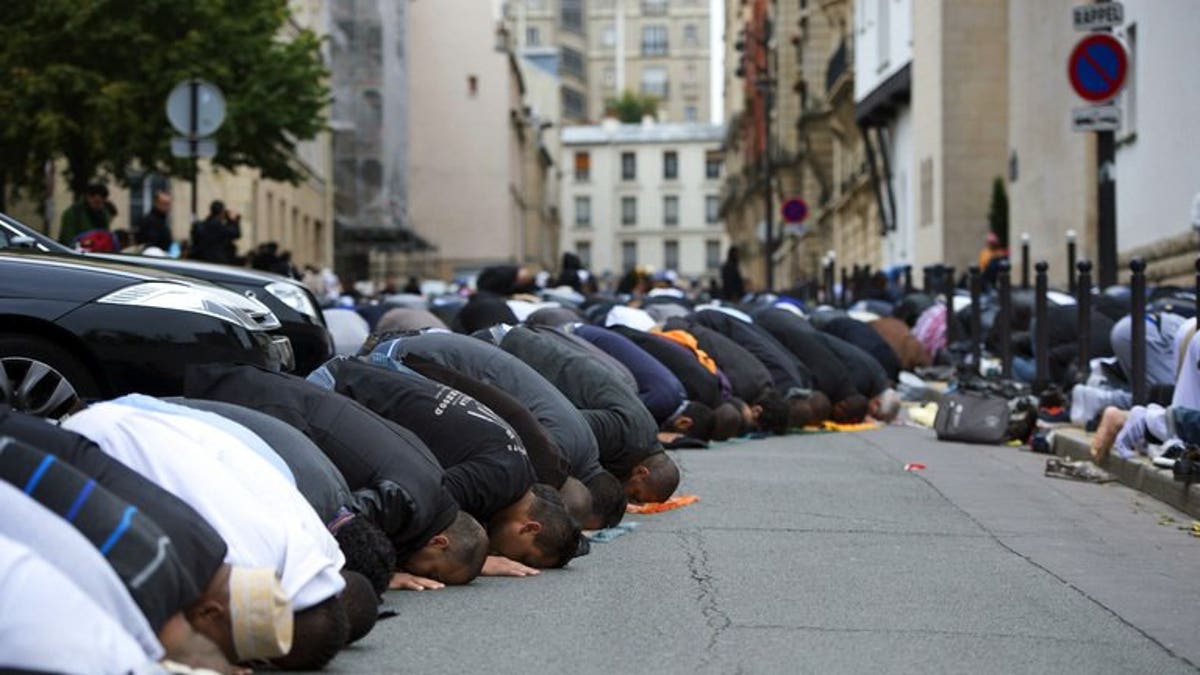 Muslims pray outside the Grande Mosque of Paris on the first day of Eid al-Adha on October 26, 2012. The European Parliament on Tuesday lifted immunity for French National Front leader Marine Le Pen, opening the way for her to face charges for likening the sight of Muslims praying in the street to Nazi occupation during World War II.